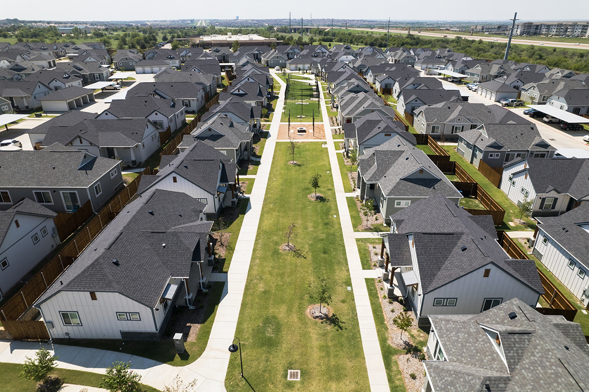 White and gray single family for rent homes with a dog park and fire pit.